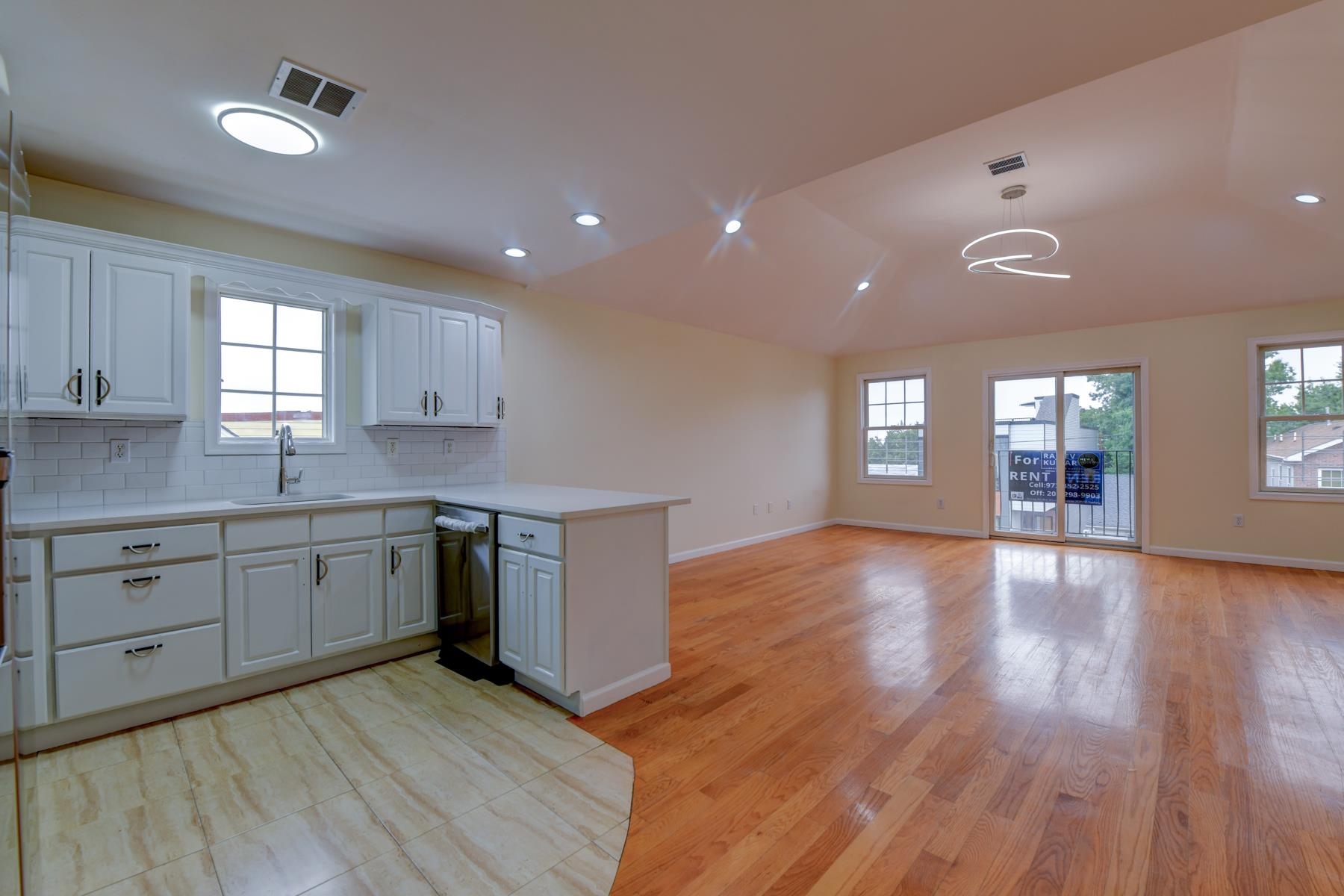 190 Terrace Avenue, Unit 2 Jersey City, NJ 07307 - Photo 2 of 29 a kitchen with cabinets wooden floor and a window