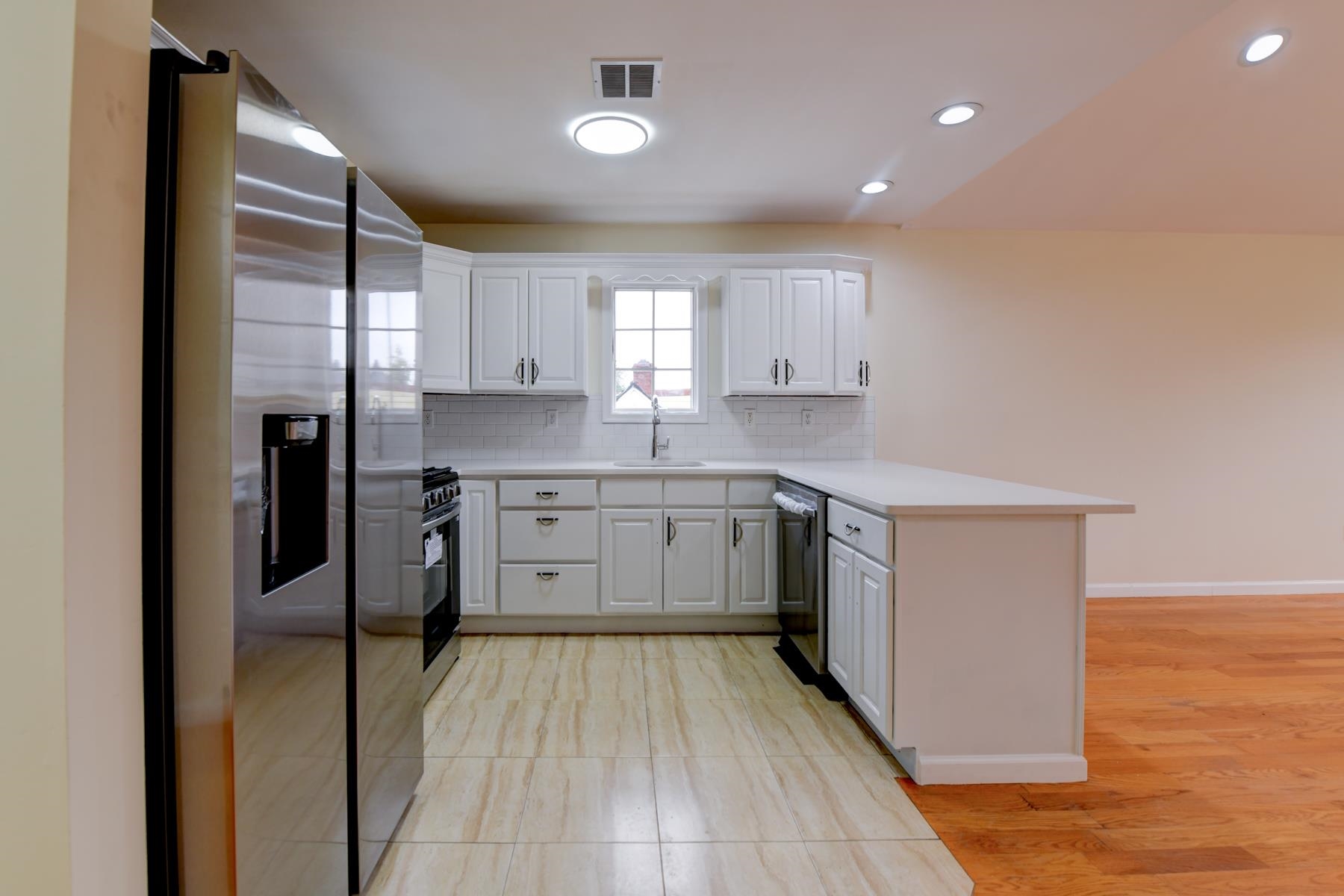 190 Terrace Avenue, Unit 2 Jersey City, NJ 07307 - Photo 3 of 29 a kitchen with a cabinets a sink stainless steel appliances and counter space