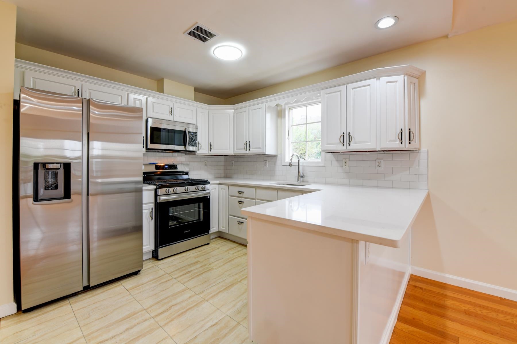 190 Terrace Avenue, Unit 2 Jersey City, NJ 07307 - Photo 5 of 29 a kitchen with a refrigerator stove and microwave