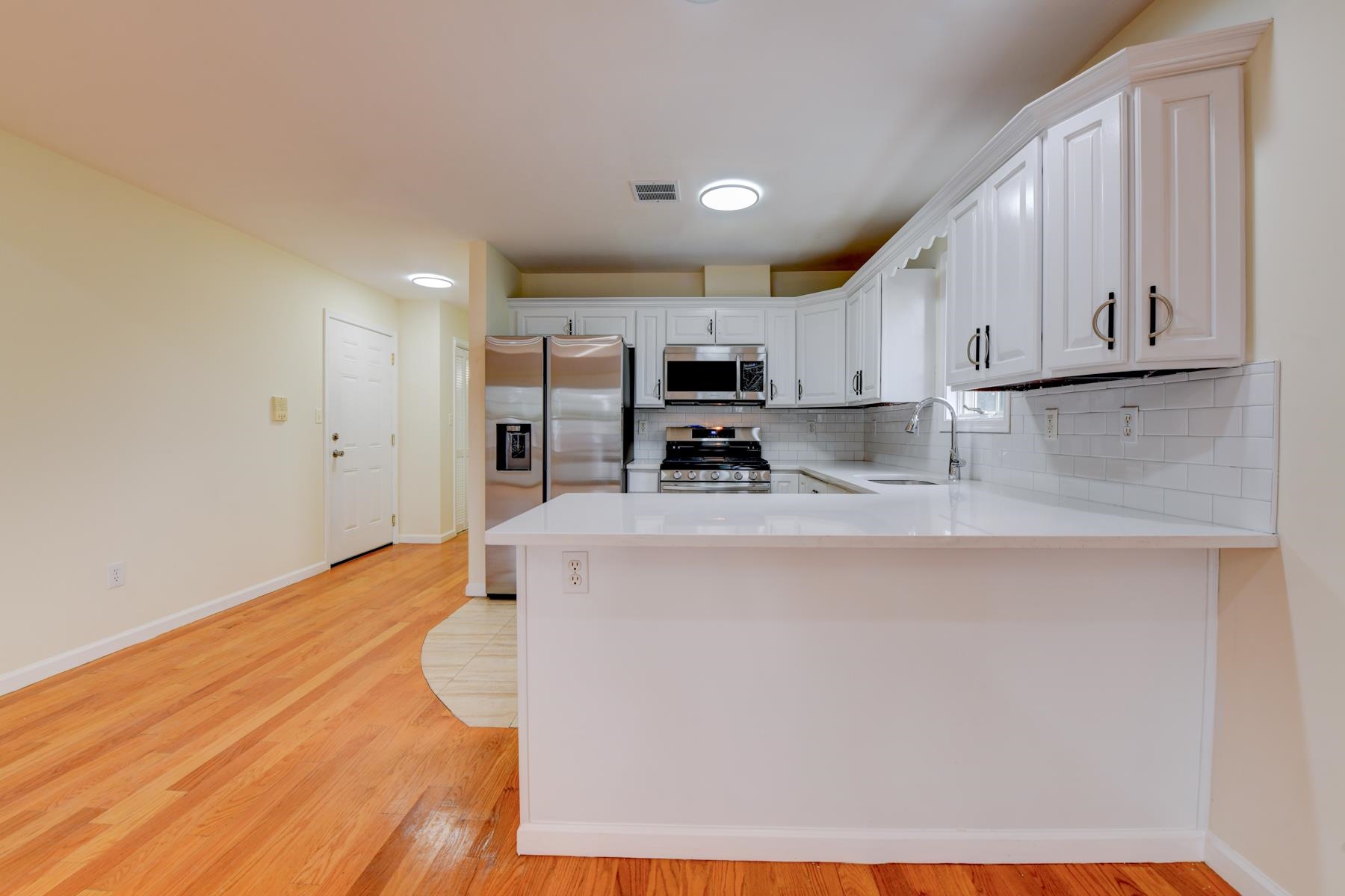190 Terrace Avenue, Unit 2 Jersey City, NJ 07307 - Photo 6 of 29 a kitchen with stainless steel appliances granite countertop a stove a sink and a refrigerator