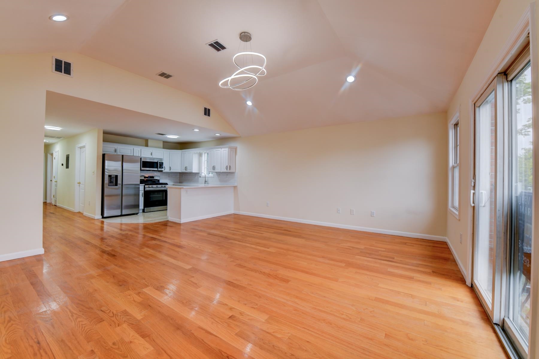 190 Terrace Avenue, Unit 2 Jersey City, NJ 07307 - Photo 7 of 29 a view of an empty room with a window and kitchen view