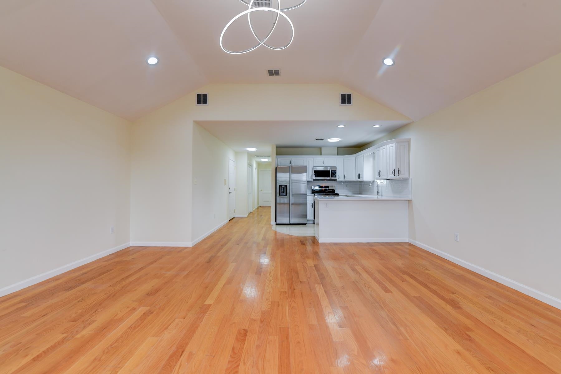190 Terrace Avenue, Unit 2 Jersey City, NJ 07307 - Photo 8 of 29 a view of kitchen and empty room with wooden floor