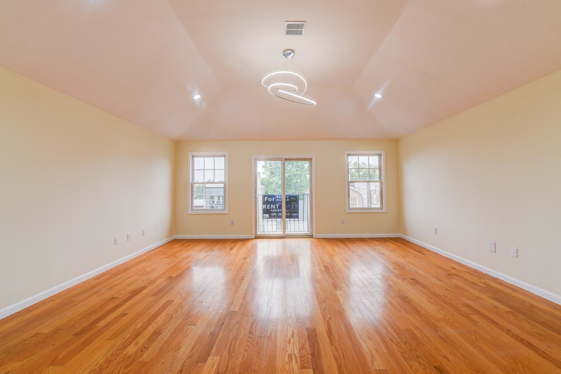 190 Terrace Avenue, Unit 2 Jersey City, NJ 07307 - Photo 9 of 29 a view of an empty room with wooden floor and a window