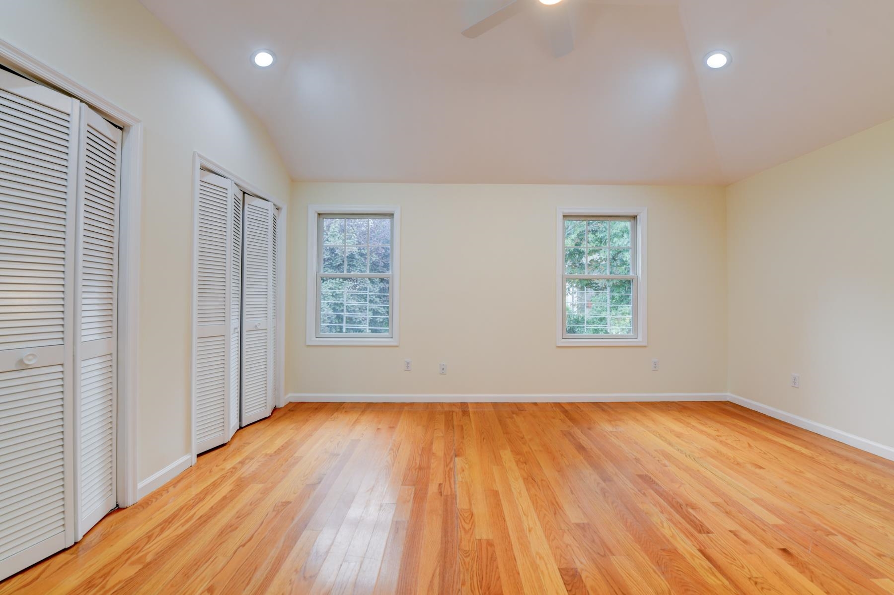 190 Terrace Avenue, Unit 2 Jersey City, NJ 07307 - Photo 10 of 29 an empty room with wooden floor and windows