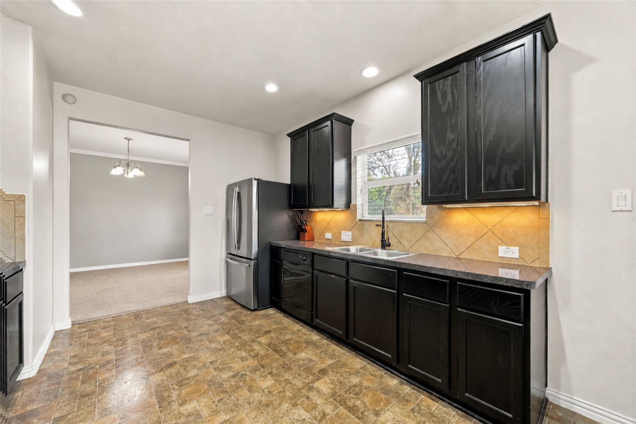 8338 Rudy Brook Way Spring, TX 77379 - Photo 8 of 33 Another view of the kitchen highlights its generous storage and convenient connection to the surrounding living areas.