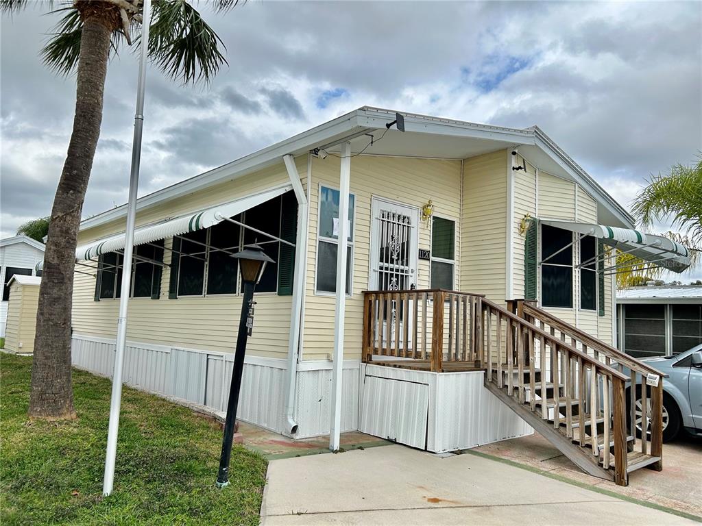a view of a house with wooden floor and a fence