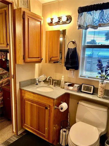 a bathroom with a toilet and a mirror
