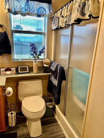 a bathroom with a toilet a sink and a shower curtain