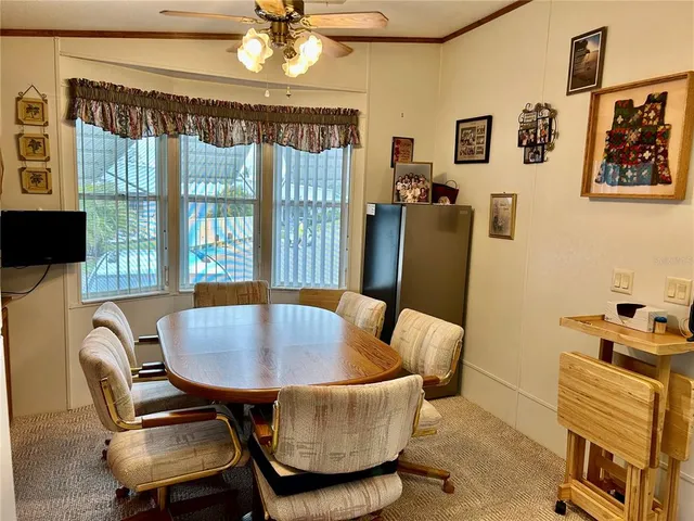 a dining room with furniture and a chandelier