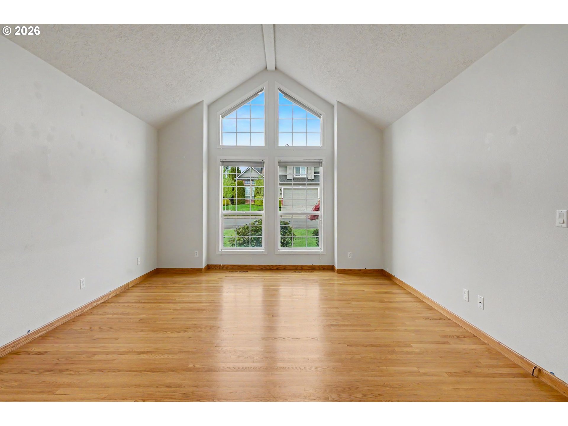 1470 Ranier Loop Northwest Salem, OR 97304 - Photo 8 of 48 a view of an empty room with wooden floor and a window