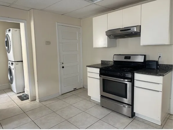 a kitchen with stainless steel appliances granite countertop a stove a refrigerator and a cabinets