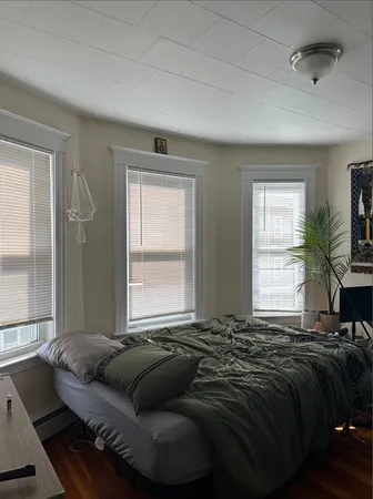 a bedroom with a bed and a window