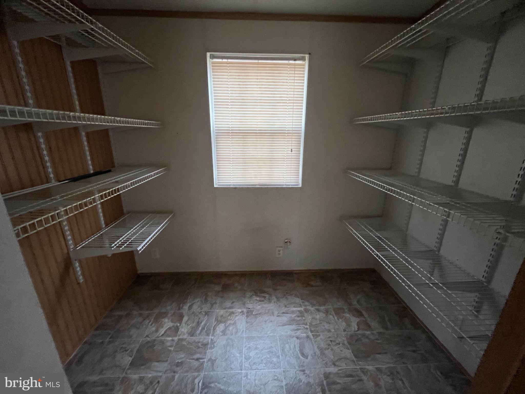 Spacious pantry with ample shelving.