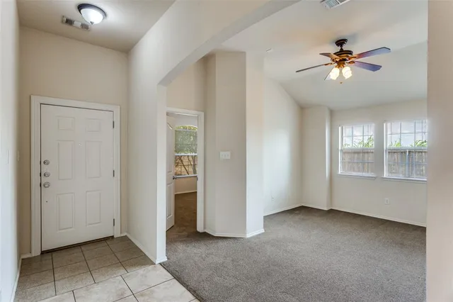 a view of a livingroom with a ceiling fan and window
