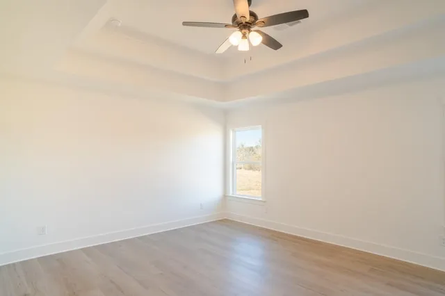 a bathroom with a granite countertop sink a mirror and shower