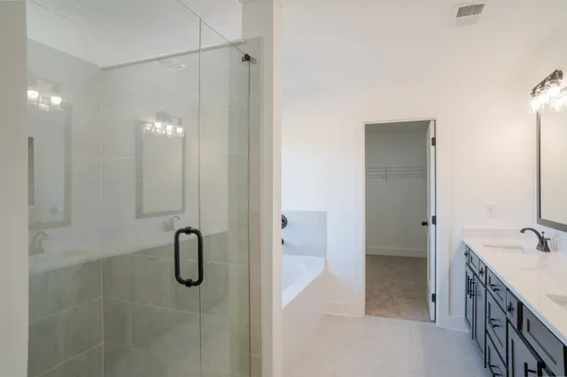 a bathroom with a window bathtub and shower