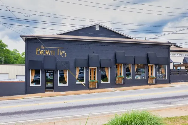 an aerial view of a house with swimming pool garden and patio