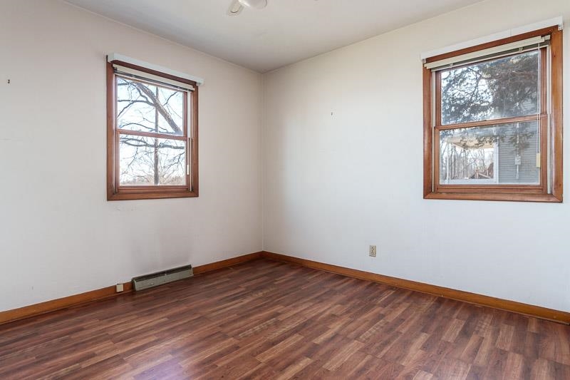 2686 Lundgren Road Pecatonica, IL 61063 - Photo 28 of 58 a view of an empty room with wooden floor and a window