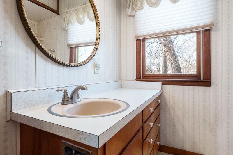 2686 Lundgren Road Pecatonica, IL 61063 - Photo 33 of 58 a bathroom with a sink a mirror a vanity and a window