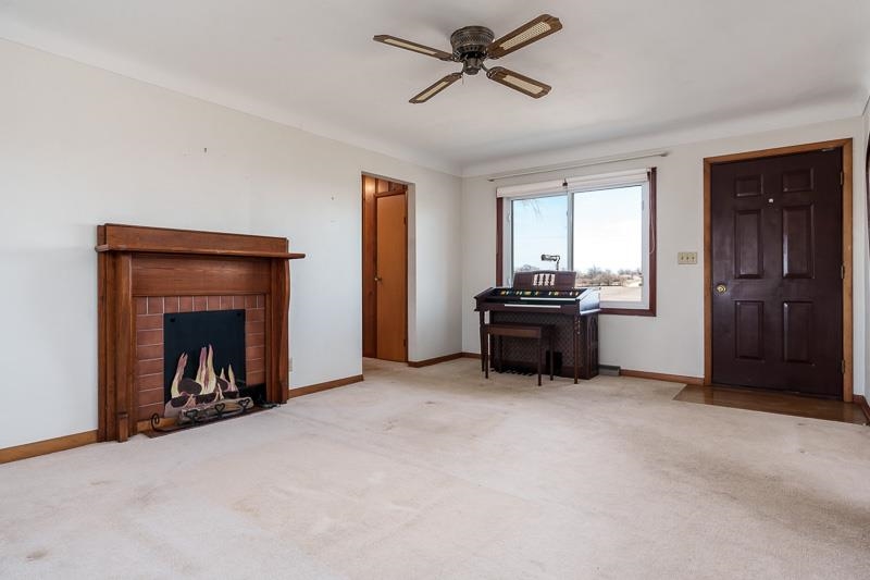 2686 Lundgren Road Pecatonica, IL 61063 - Photo 9 of 58 a living room with a fireplace and a window