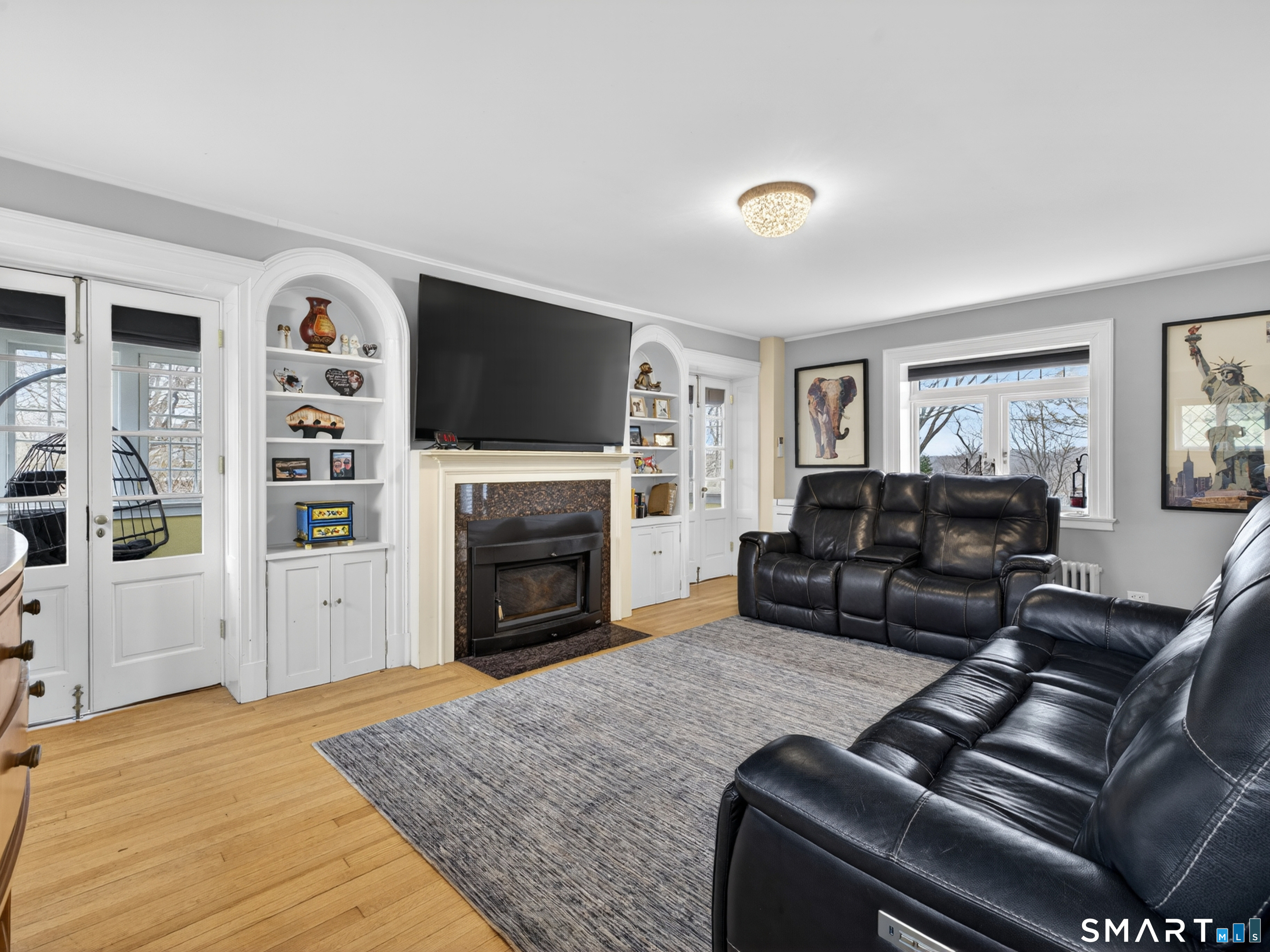 76 Starr Hill Road Groton, CT 06340 - Photo 4 of 40 a living room with furniture a flat screen tv and a fireplace