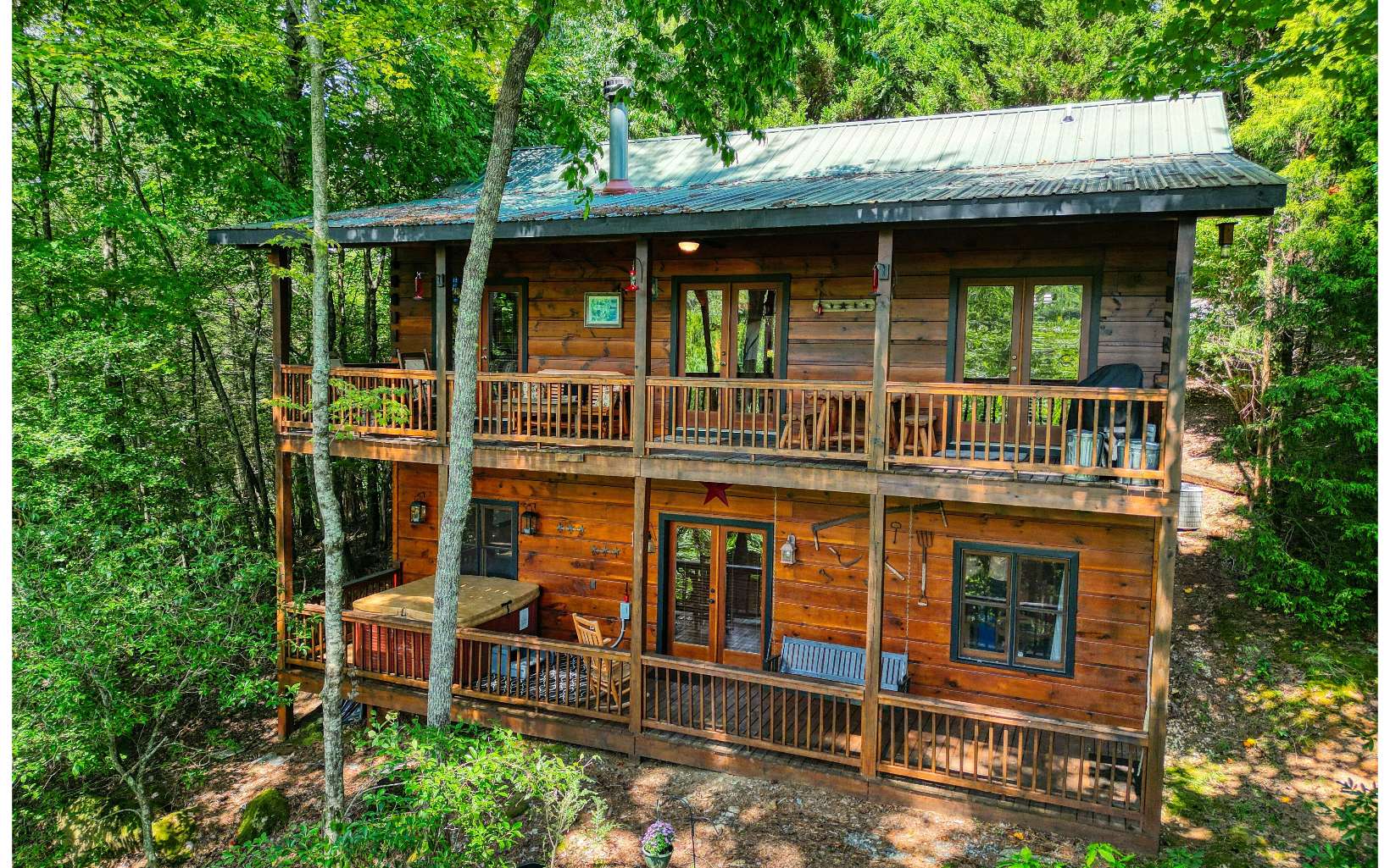 206 Mountain View Road Cherry Log, GA 30522 - Photo 2 of 49 a view of a house with large windows and a small yard