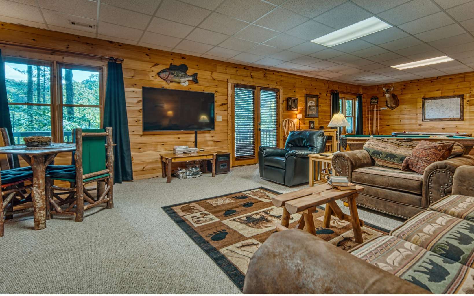 206 Mountain View Road Cherry Log, GA 30522 - Photo 30 of 49 a living room with furniture a flat screen tv and floor to ceiling window