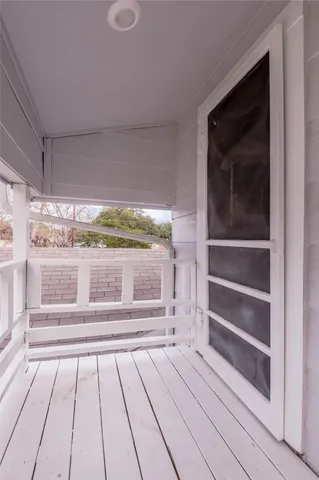 a view of wooden floor and windows in a room