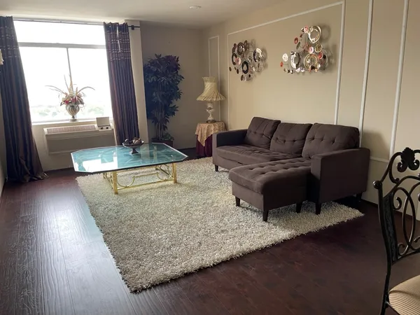a living room with furniture and a large window