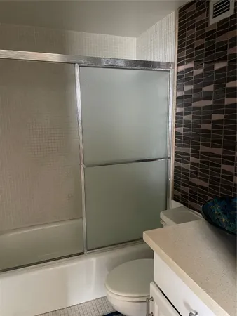 a bathroom with a shower and a toilet