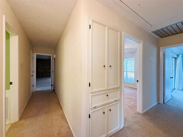 a view of a hallway with wooden cabinet and entryway