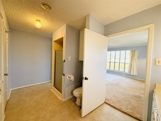a bathroom with a tub mirror and window