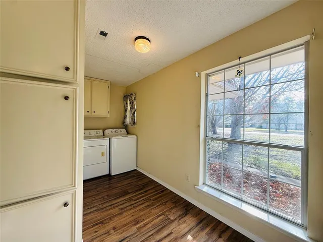 a view of a room with wooden floor and cabinet