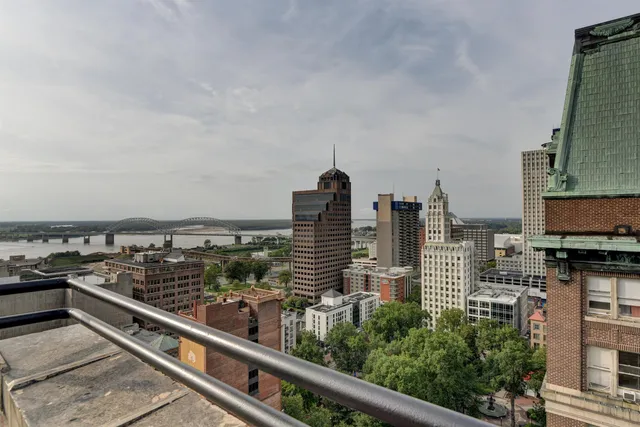 a view of a roof deck with furniture