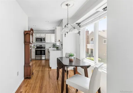 a view of a dining room with furniture window and wooden floor
