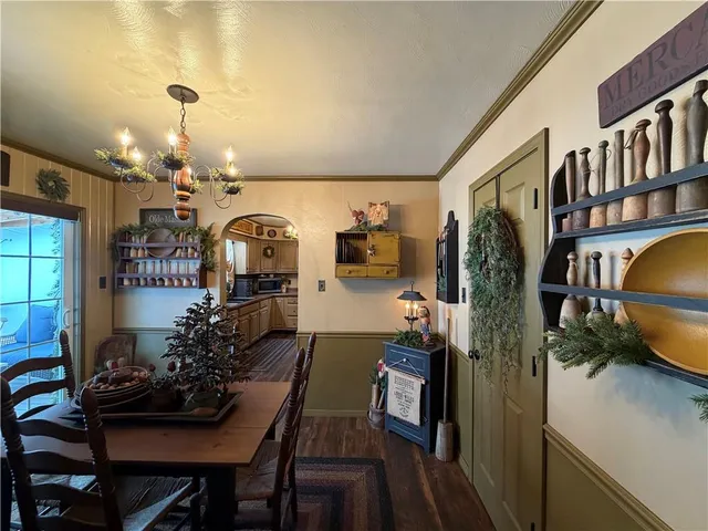 a view of a dining room with furniture and a chandelier