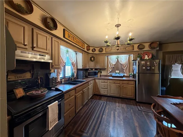 a kitchen with stainless steel appliances granite countertop a stove and cabinets
