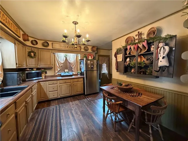 a kitchen with stainless steel appliances a stove a sink dishwasher and cabinets with wooden floor