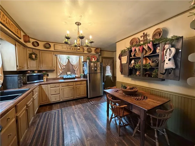 a kitchen with stainless steel appliances a stove a sink dishwasher and cabinets with wooden floor