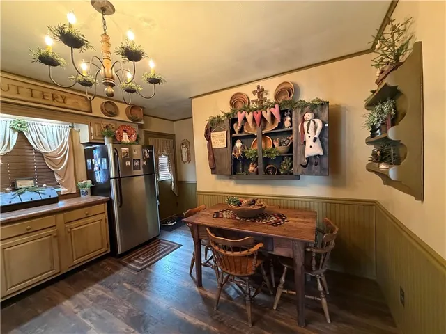 a view of a dining room with furniture and chandelier