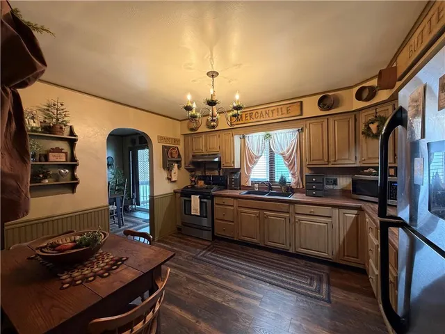 a kitchen with sink stove and cabinets