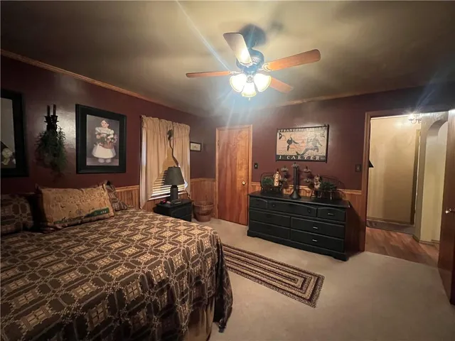 a bedroom with a bed and a chandelier