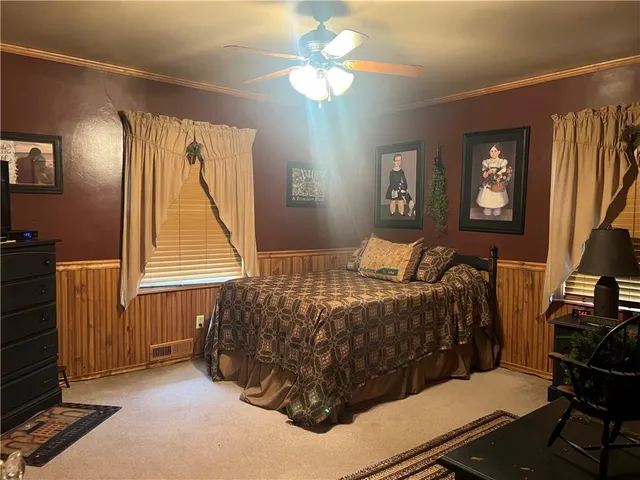 a bedroom with a bed and a chandelier