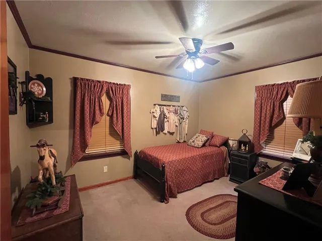a bedroom with double bed and a chandelier
