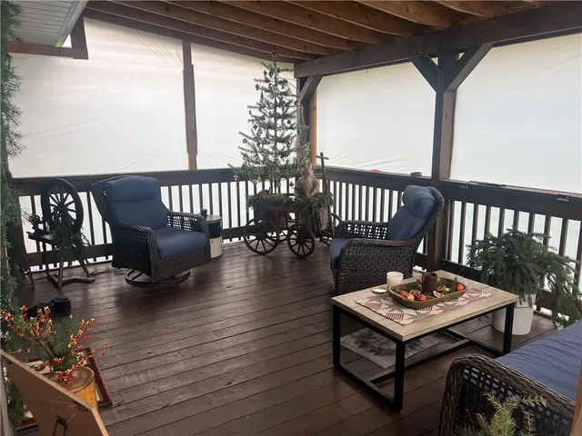 a dining room with wooden floor a glass table and chairs