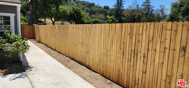 a view of balcony with wooden fence
