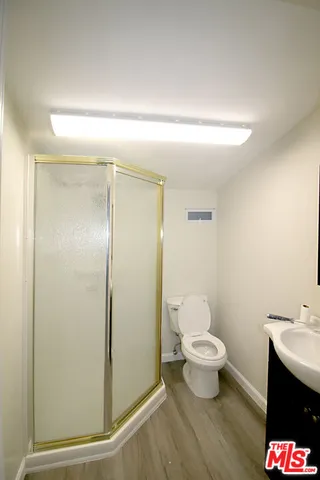 a bathroom with a toilet sink and shower