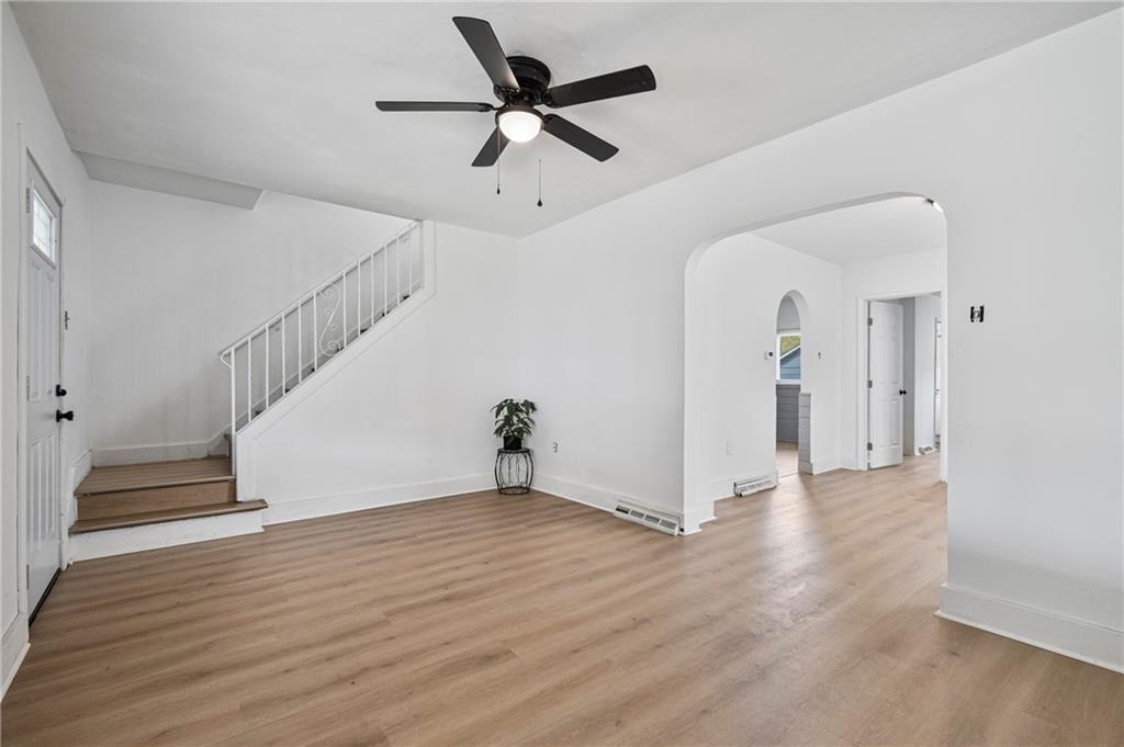 1716 Davidson Street Aliquippa, PA 15001 - Photo 6 of 34 a view of an empty room with wooden floor and a ceiling fan