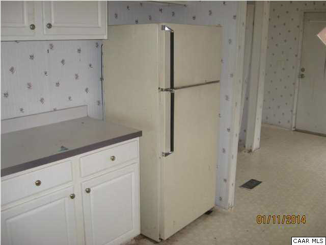 7389 Porters Road Esmont, VA 22937 - Photo 4 of 4 a white refrigerator freezer sitting in a kitchen