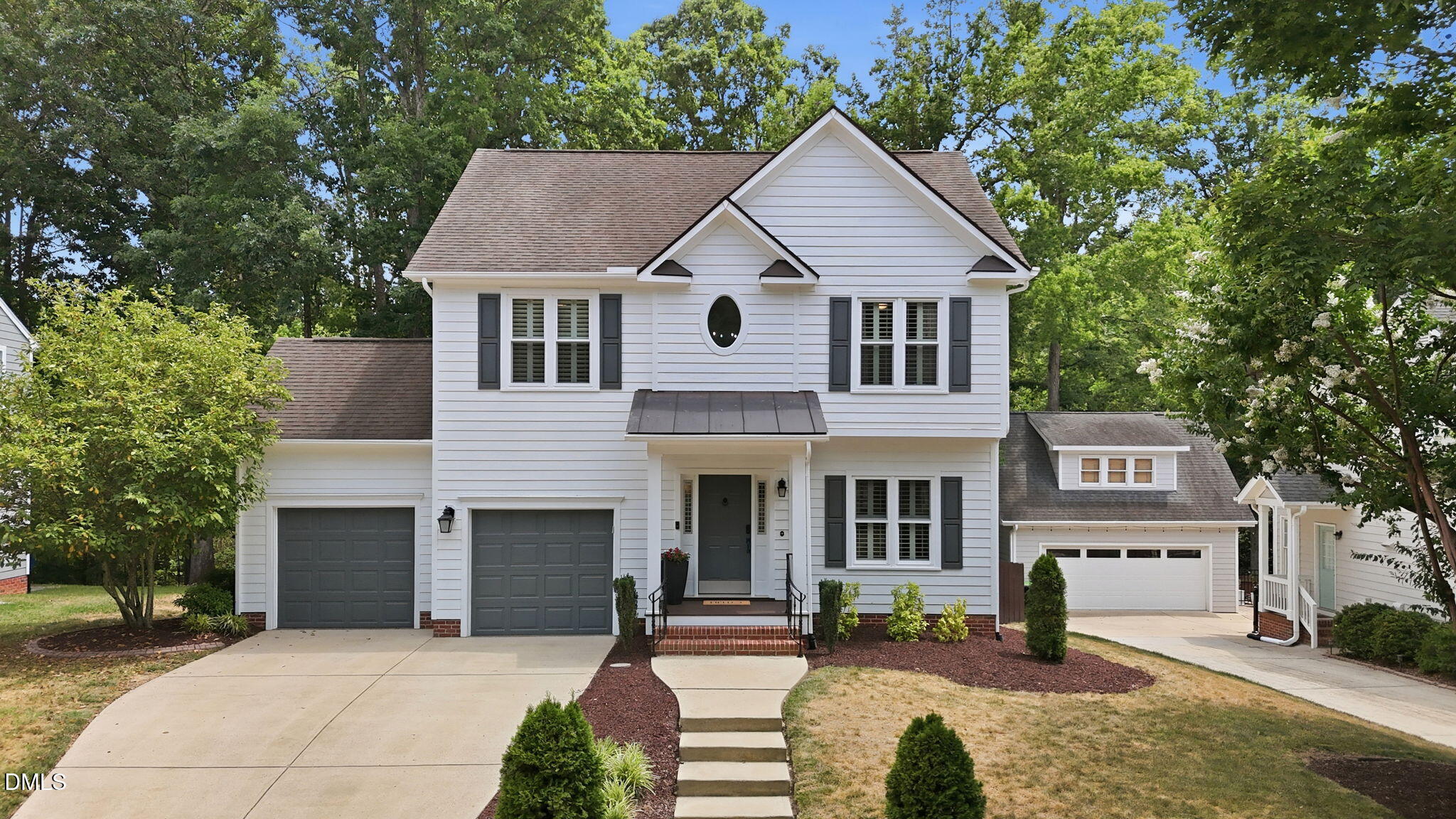 1716 Farmington Grove Drive Raleigh, NC 27614 - Photo 2 of 41 a front view of a house with a garden and trees